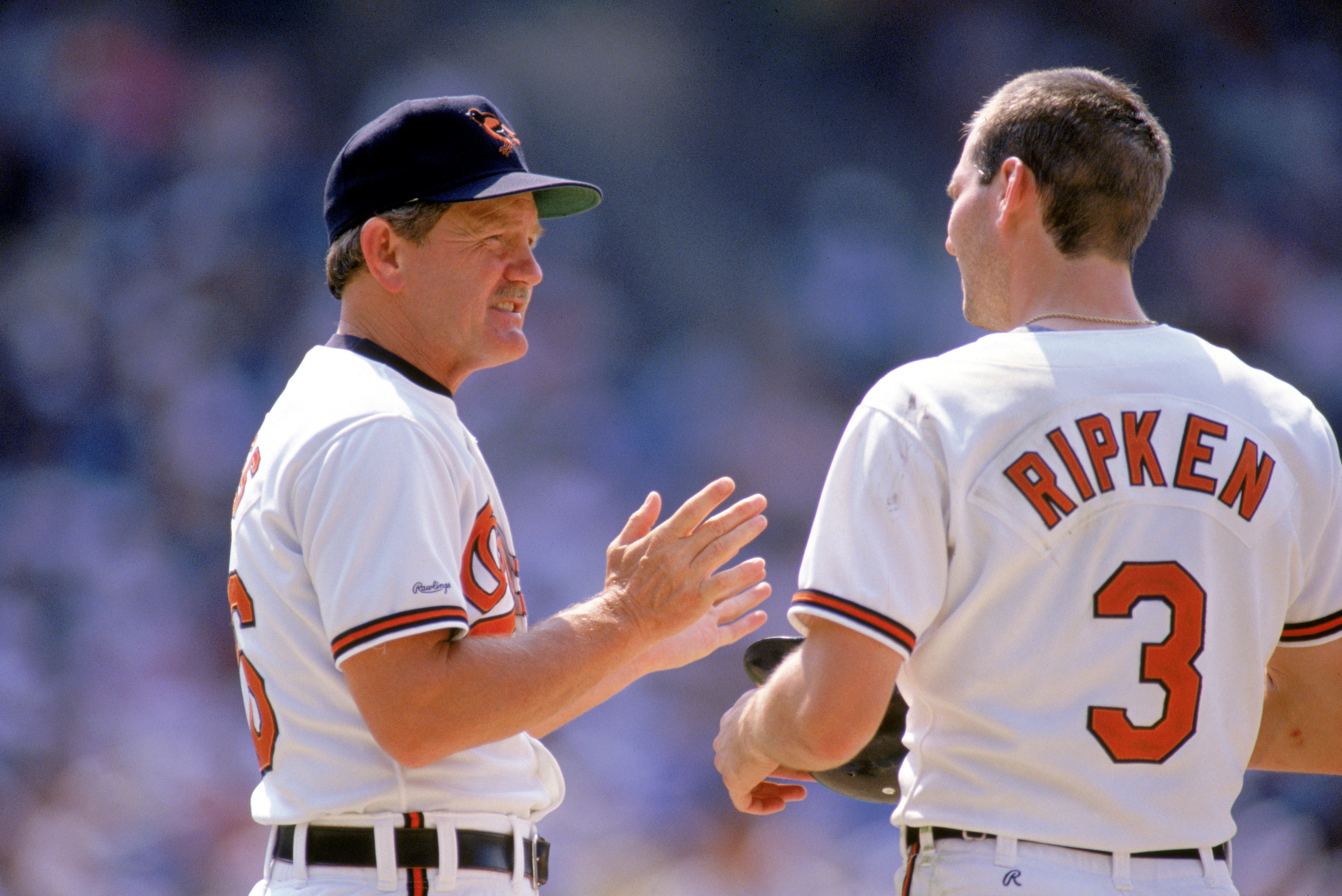 1990:  Coach Johnny Oates of the Baltimore Orioles talks to pitcher Billy Ripken #3 during a game in the 1990 season. (Photo by: Rick Stewart/Getty Images)