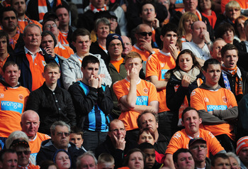 MANCHESTER, ENGLAND - MAY 22: Blackpool fans look dejected during the Barclays Premier League match between Manchester United and Blackpool at Old Trafford on May 22, 2011 in Manchester, England. (Photo by Shaun Botterill/Getty Images)