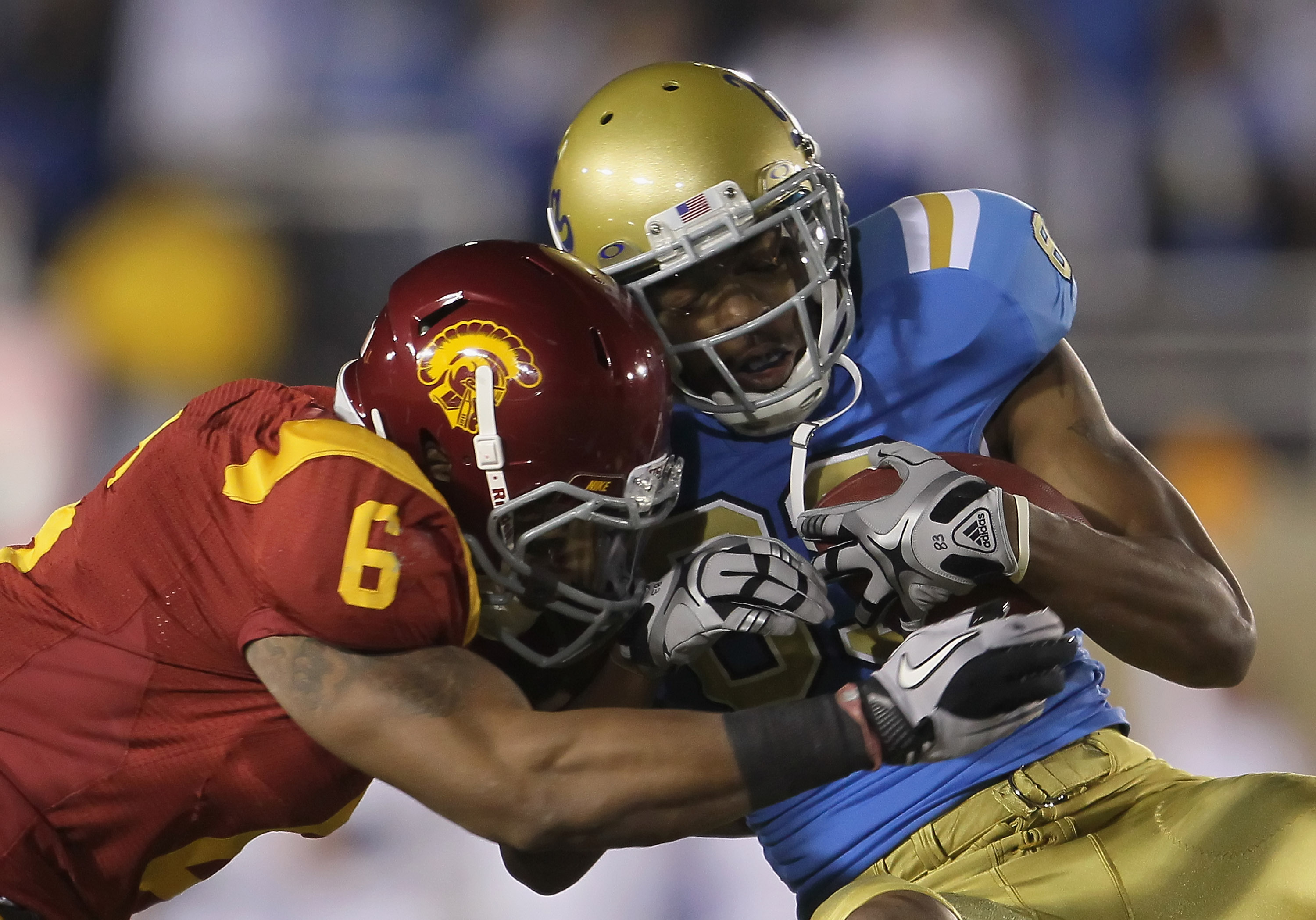 PASADENA, CA - DECEMBER 04:  Malcolm Smith #6 of the USC Trojans tackles Nelson Rosario #83 of the UCLA Bruins during the first half at the Rose Bowl on December 4, 2010 in Pasadena, California. USC defeated UCLA 28-14.  (Photo by Jeff Gross/Getty Images)