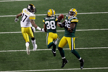 ARLINGTON, TX - FEBRUARY 06:  Nick Collins #36 of the Green Bay Packers makes an interception and runs 37 yards for a touchdown in the first quarter against the Pittsburgh Steelers during Super Bowl XLV at Cowboys Stadium on February 6, 2011 in Arlington,
