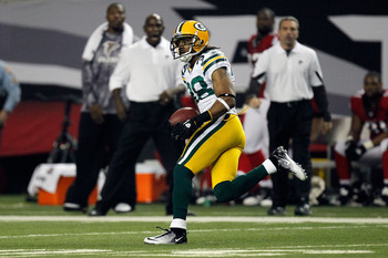 ATLANTA, GA - JANUARY 15:  Tramon Williams ##8 of the Green Bay Packers returns an interception 70-yards for a touchdown in the second quarter against the Atlanta Falcons during their 2011 NFC divisional playoff game at Georgia Dome on January 15, 2011 in