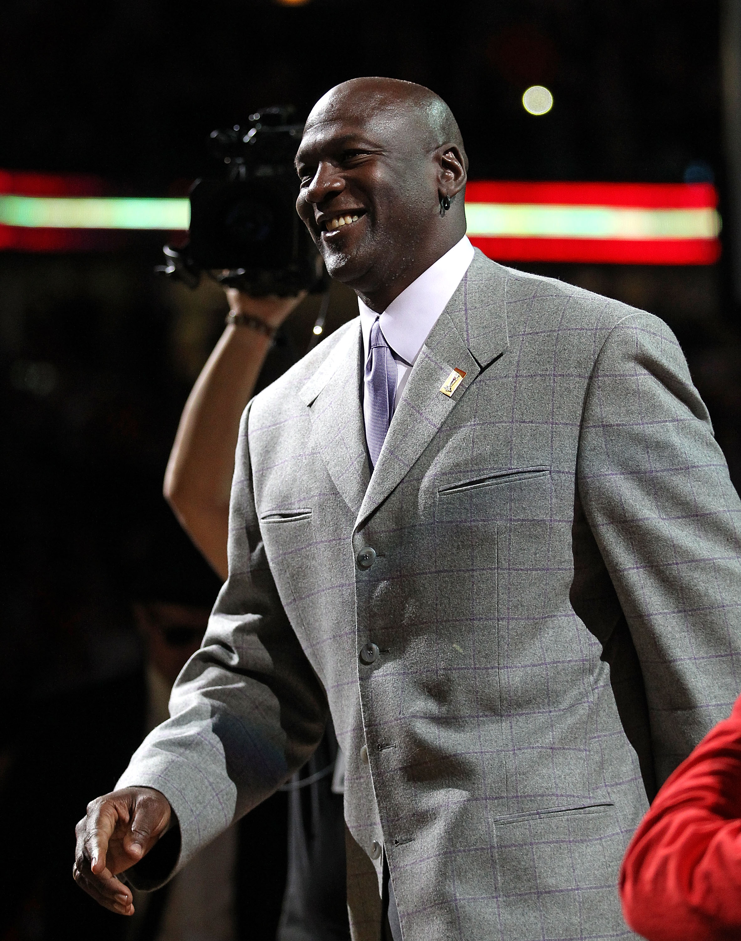 CHICAGO, IL - MARCH 12: Former player Michael Jordan of the Chicago Bulls smiles as he is introduced to  the crowd during a 20th anniversary recognition ceremony of the Bulls 1st NBA Championship in 1991 during half-time of a game bewteen the Bulls and th