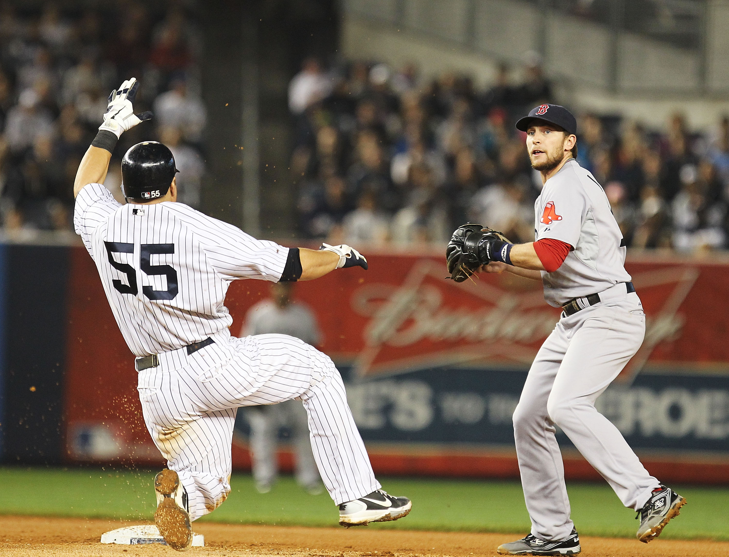 NEW YORK, NY - MAY 15: Jed Lowrie #12 of the Boston Red Sox reaches to get the force out on Russell Martin #55 of the New York Yankees during their game on May 15, 2011 at Yankee Stadium in the Bronx borough of New York City. (Photo by Al Bello/Getty Im