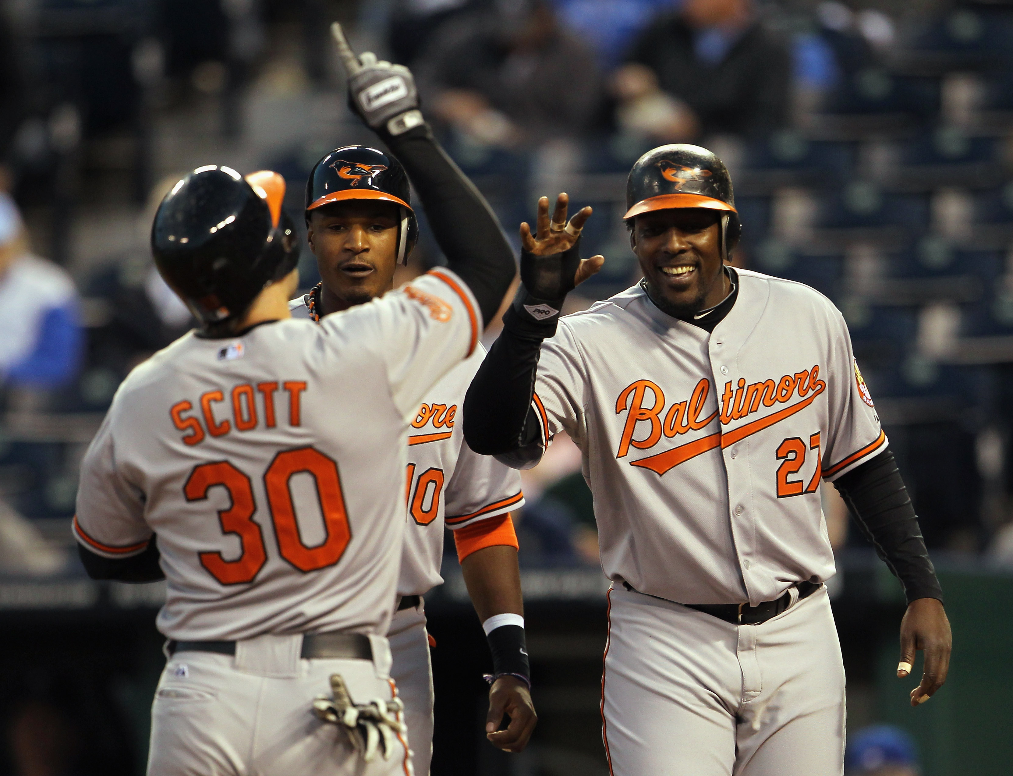KANSAS CITY, MO - MAY 03: Luke Scott #30 of the Baltimore Orioles is congratulated by Adam Jones #10 and Vladimir Guerrero #27 after hitting a 3-run home run during the 4th inning of the game against the Kansas City Royals on May 3, 2011 at Kauffman Stad
