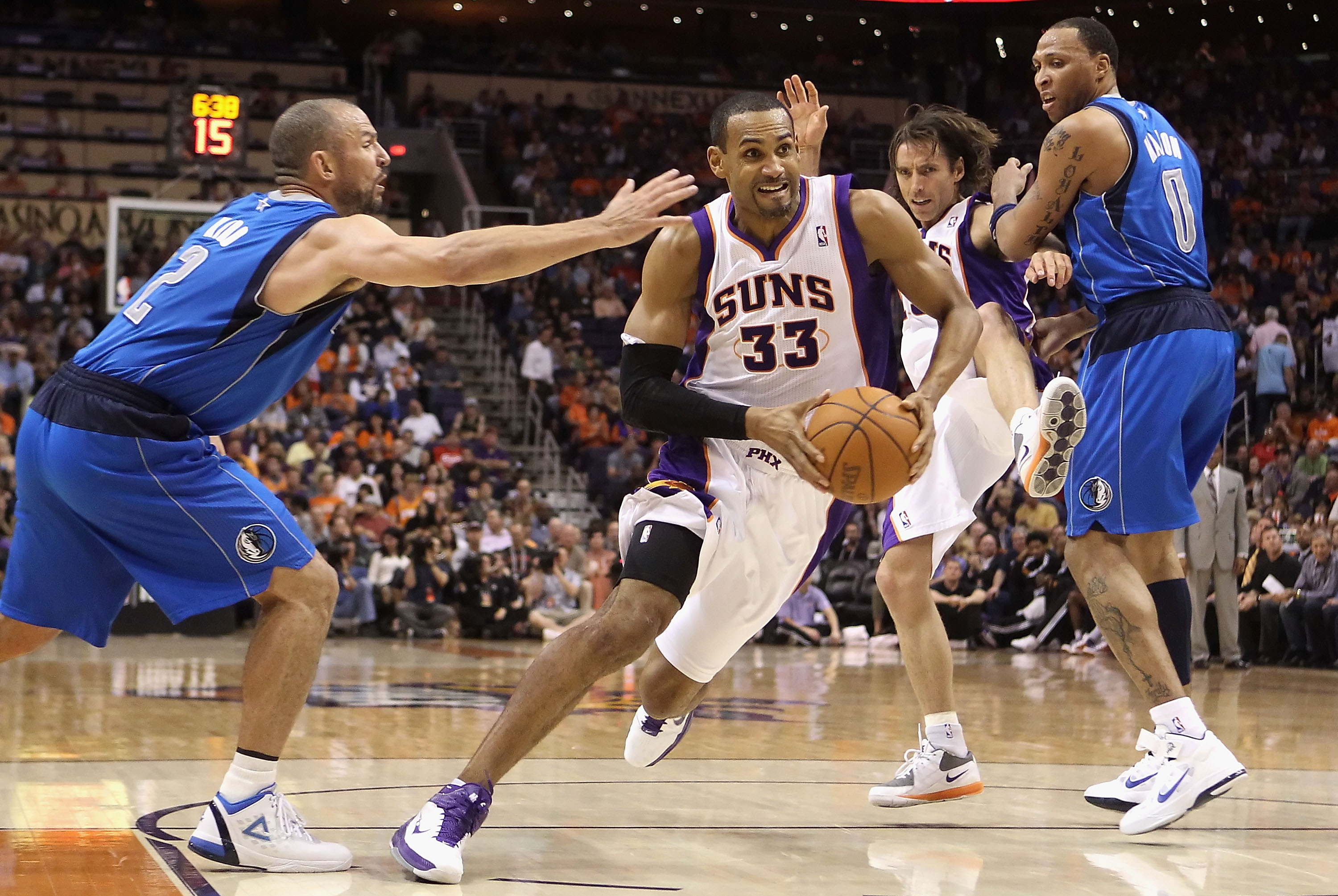 PHOENIX, AZ - MARCH 27:  Grant Hill  #33 of the Phoenix Suns drives the ball past  Jason Kidd #2 of the Dallas Mavericks during the NBA game at US Airways Center on March 27, 2011 in Phoenix, Arizona.  The Mavericks defeated the Suns 91-83.  NOTE TO USER: