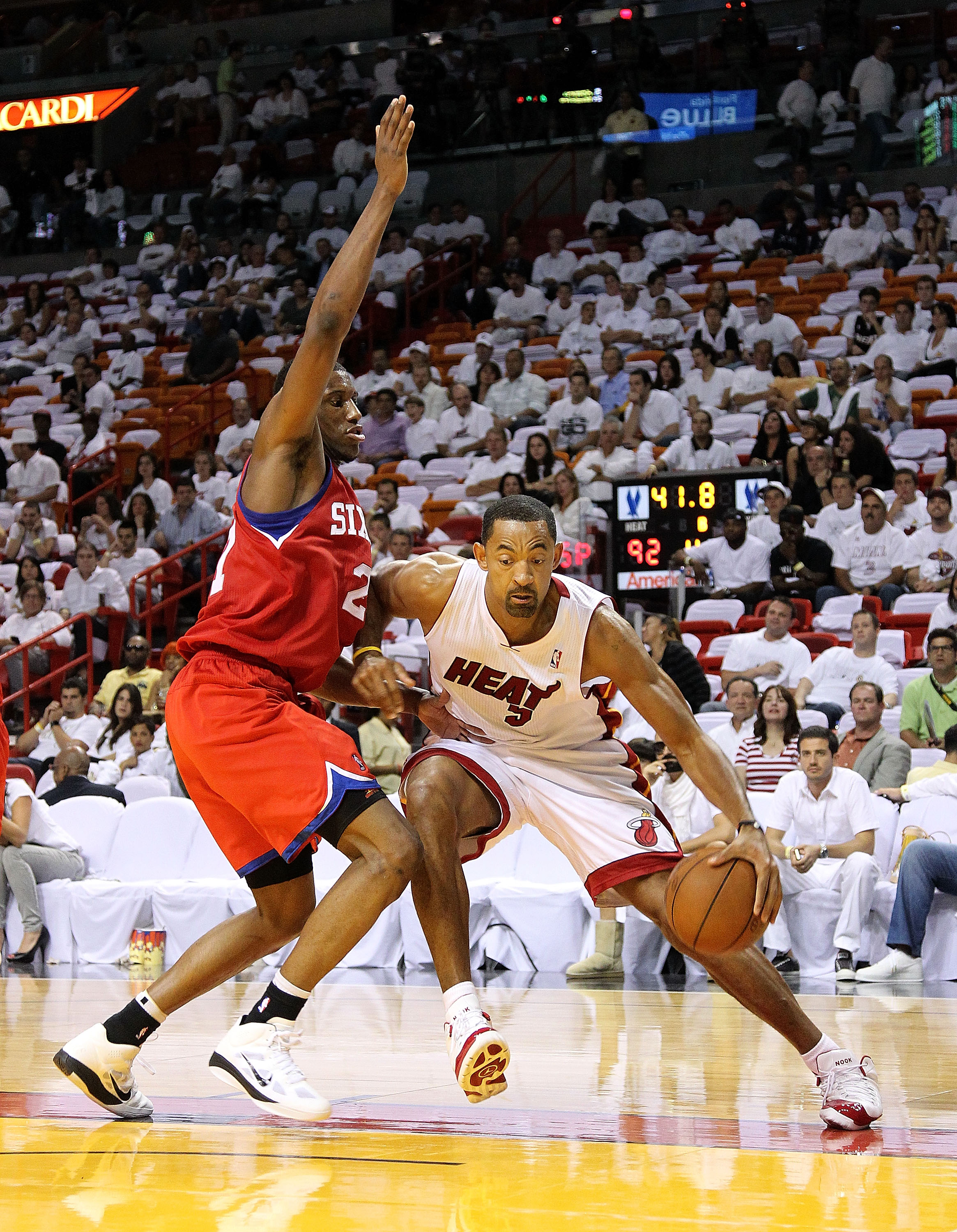 MIAMI, FL - APRIL 18:  Juwan Howard #5 of the Miami Heat drives around Thaddeus Young #21 of the Philadelphia 76ers during game two of the Eastern Conference Quarterfinals at American Airlines Arena on April 18, 2011 in Miami, Florida. NOTE TO USER: User