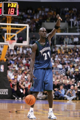 LOS ANGELES- MAY 25: Kevin Garnett #21 of the Minnesota Timberwolves signals a play as he dribbles the ball against the Los Angeles Lakers in Game three of the Western Conference Finals during the 2004 NBA Playoffs at Staples Center on May 25, 2004 in Lo