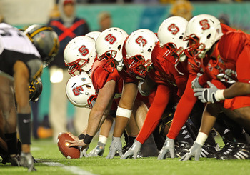 ORLANDO, FL - DECEMBER 28:  The North Carolina State Wolfpack snap the ball during the Champs Sports Bowl against the West Virginia Mountineers at Florida Citrus Bowl Stadium on December 28, 2010 in Orlando, Florida.  (Photo by Mike Ehrmann/Getty Images)