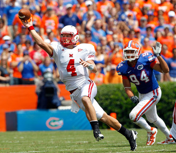 GAINESVILLE, FL - SEPTEMBER 04:  Zac Dysert #4 of the Miami University RedHawks attempts a pass while being pressured by Justin Trattou #94 of the Florida Gators at Ben Hill Griffin Stadium on September 4, 2010 in Gainesville, Florida.  (Photo by Sam Gree