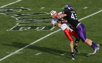 PASADENA, CA - JANUARY 01:  Quarterback Scott Tolzien #16 of the Wisconsin Badgers is hit by linebacker Tank Carder #43 of the TCU Horned Frogs during the 97th Rose Bowl game on January 1, 2011 in Pasadena, California.  (Photo by Stephen Dunn/Getty Images