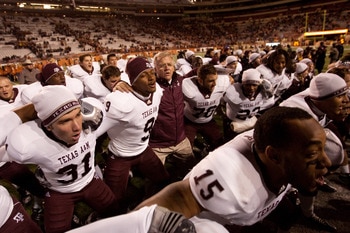 AUSTIN, TX - NOVEMBER 25: Mike Sherman, head coach of Texas A&M, joins players in a post-game singing of the Aggie War Hymn following Texas A&M's 24-17 win over the University of Texas at Darrell K. Royal-Texas Memorial Stadium on November 25, 2010 in Au