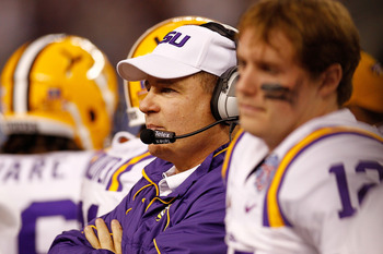 ARLINGTON, TX - JANUARY 07:  Head coach Les Miles of the Louisiana State University Tigers talks wthi his team during a timeout against the Texas A&M Aggies during the AT&T Cotton Bowl at Cowboys Stadium on January 7, 2011 in Arlington, Texas.  (Photo by