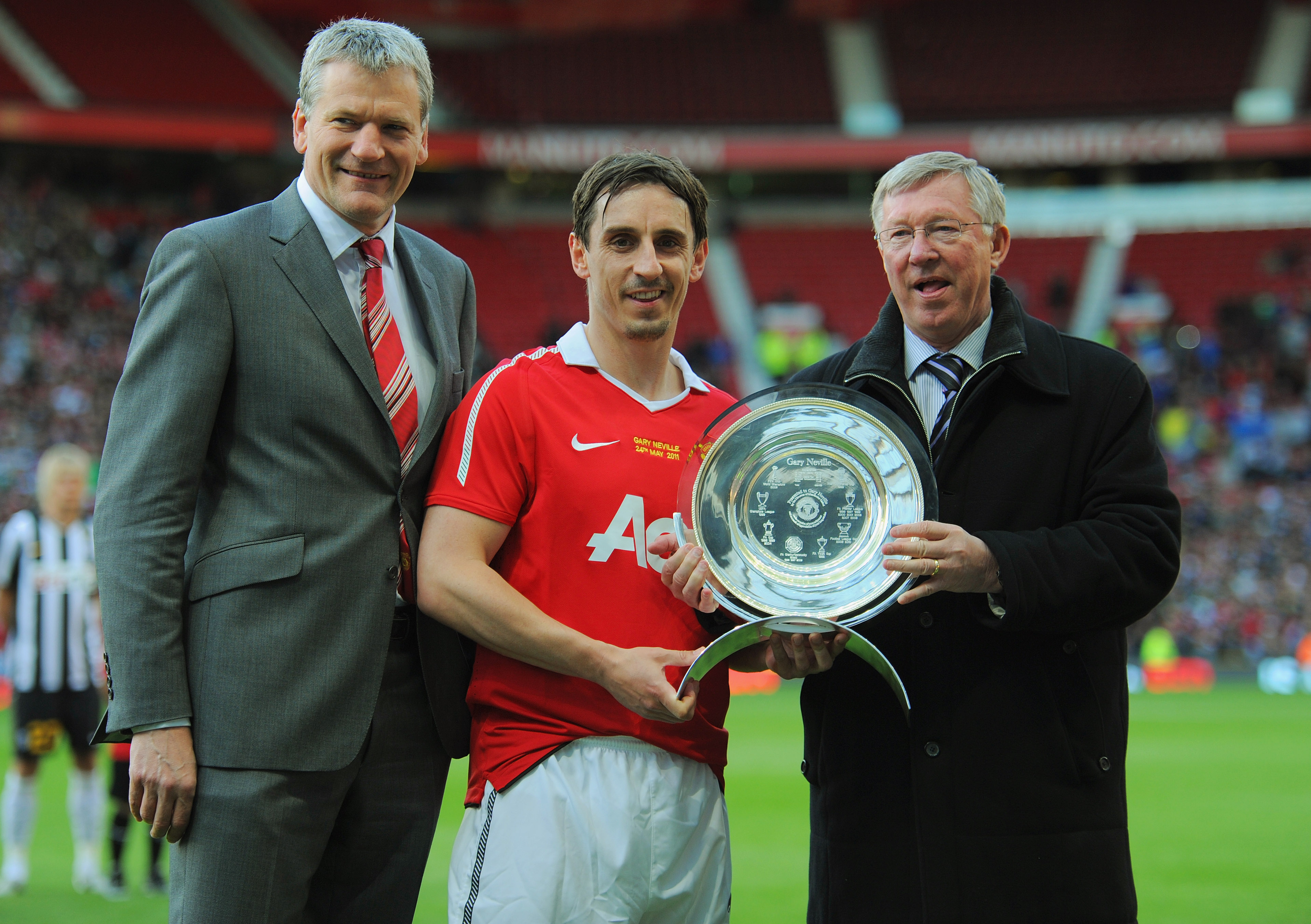 MANCHESTER, ENGLAND - MAY 24: Manchester United Chief Executive David Gill and manager Sir Alex Ferguson present Gary Neville with a plate during the Gary Neville Testimonial Match between Manchester United and Juventus at Old Trafford on May 24, 2011 in