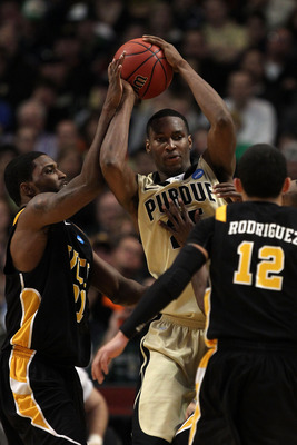 CHICAGO, IL - MARCH 20:  JaJuan Johnson #25 of the Purdue Boilermakers looks to pass against Jamie Skeen #21 and Joey Rodriguez #12 of the Virginia Commonwealth Rams in the second half during the third round of the 2011 NCAA men's basketball tournament at