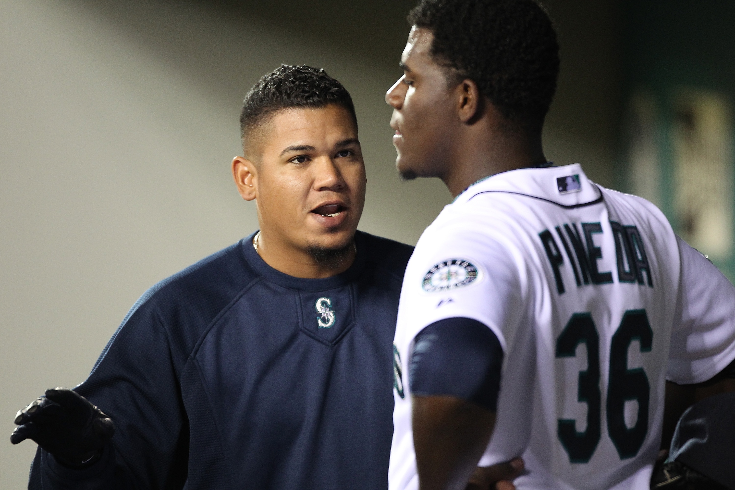 SEATTLE - APRIL 12: Felix Hernandez #34 of the Seattle Mariners talks with starting pitcher Michael Pineda #36 after he was removed from the game in the eighth inning against the Toronto Blue Jays at Safeco Field on April 12, 2011 in Seattle, Washington.