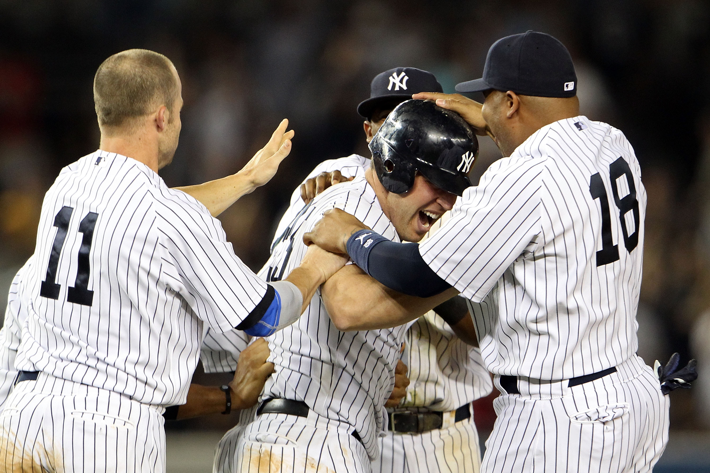 NEW YORK, NY - MAY 24: Mark Teixeira #25 of the New York Yankees celebrates with Brett Gardner #11 and Andruw Jones #18 after hitting a game winning RBI in the ninth inning against the Toronto Blue Jays at Yankee Stadium on May 24, 2011 in the Bronx boro