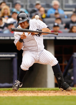 NEW YORK - MAY 22:  Francisco Cervelli #17 of the New York Yankees is hit by the pitch as he attempts to bunt in the seventh inning during the game against the New York Mets on May 22, 2011 at Yankee Stadium in the Bronx borough of New York City.  (Photo