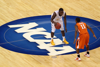 TAMPA, FL - MARCH 17:  Darryl Bryant #25 of the West Virginia Mountaineers brings the ball up court against Andre Young #11 of the Clemson Tigers during the second round of the 2011 NCAA men's basketball tournament at St. Pete Times Forum on March 17, 201