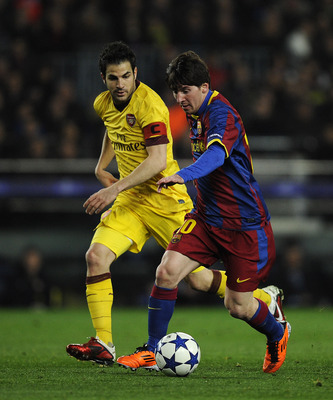 BARCELONA, SPAIN - MARCH 08:  Lionel Messi of FC Barcelona (R) duels for the ball against Cesc Fabregas of Arsenal during the UEFA Champions League round of 16 second leg match between Barcelona and Arsenal at the Camp Nou stadium on March 8, 2011 in Barc