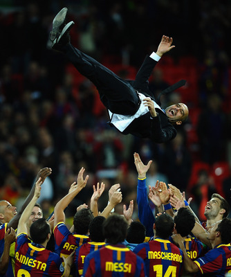 LONDON, ENGLAND - MAY 28: Josep Guardiola manager of FC Barcelona is thrown in the air as Barcelona celebrate victory in UEFA Champions League final between FC Barcelona and Manchester United FC at Wembley Stadium on May 28, 2011 in London, England.  (Pho