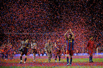 BARCELONA, SPAIN - MAY 15:  Xavi Hernandez of FC Barcelona (R) aknowledges spectators during the celebrations for winning La Liga after the La Liga match between Barcelona and Deportivo La Coruna at Camp Nou Stadium on May 15, 2011 in Barcelona, Spain.  (