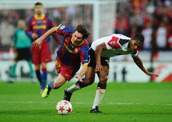 LONDON, ENGLAND - MAY 28:  Lionel Messi of FC Barcelona (L) tangles with Luis Antonio Valencia of Manchester United during the UEFA Champions League final between FC Barcelona and Manchester United FC at Wembley Stadium on May 28, 2011 in London, England.
