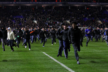 BIRMINGHAM, ENGLAND - DECEMBER 01:  Birmingham fans are chased off the pitch by police after the Carling Cup Quarter Final between Birmingham City and Aston Villa at St Andrews on December 1, 2010 in Birmingham, England.  (Photo by Stu Forster/Getty Image