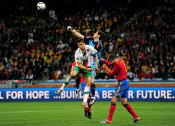 CAPE TOWN, SOUTH AFRICA - JUNE 29:  Iker Casillas of Spain defends an attack by Cristiano Ronaldo of Portugal during the 2010 FIFA World Cup South Africa Round of Sixteen match between Spain and Portugal at Green Point Stadium on June 29, 2010 in Cape Tow