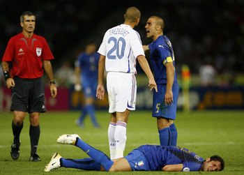 BERLIN - JULY 09: David Trezeguet (L) of France and Fabio Cannavaro (R) of Italy argue, whilst Marco Materazzi of Italy lies injured, after being headbutted  in the chest by Zinedine Zidane of France during the FIFA World Cup Germany 2006 Final match betw