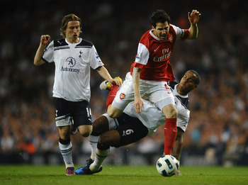 LONDON, ENGLAND - APRIL 20:  Cesc Fabregas of Arsenal is tackled by Tom Huddlestone of Spurs during the Barclays Premier League match between Tottenham Hotspur and Arsenal at White Hart Lane on April 20, 2011 in London, England.  (Photo by Laurence Griffi