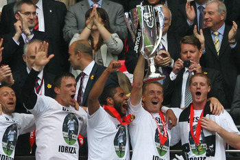 LONDON, ENGLAND - MAY 30: Garry Monk, Captain of Swansea leads celebrations with the trophy after winning the npower Championship Playoff Final between Reading and Swansea City at Wembley Stadium on May 30, 2011 in London, England. (Photo by Dean Mouhta