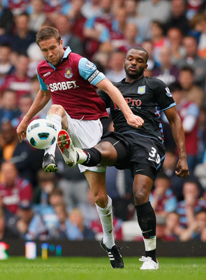 LONDON, ENGLAND - APRIL 16: Matthew Upson of West Ham United and Darren Bent of Aston Villa battle for the ball during the Barclays Premier League match between West Ham United and Aston Villa at the Boleyn Ground on April 16, 2011 in London, England. (