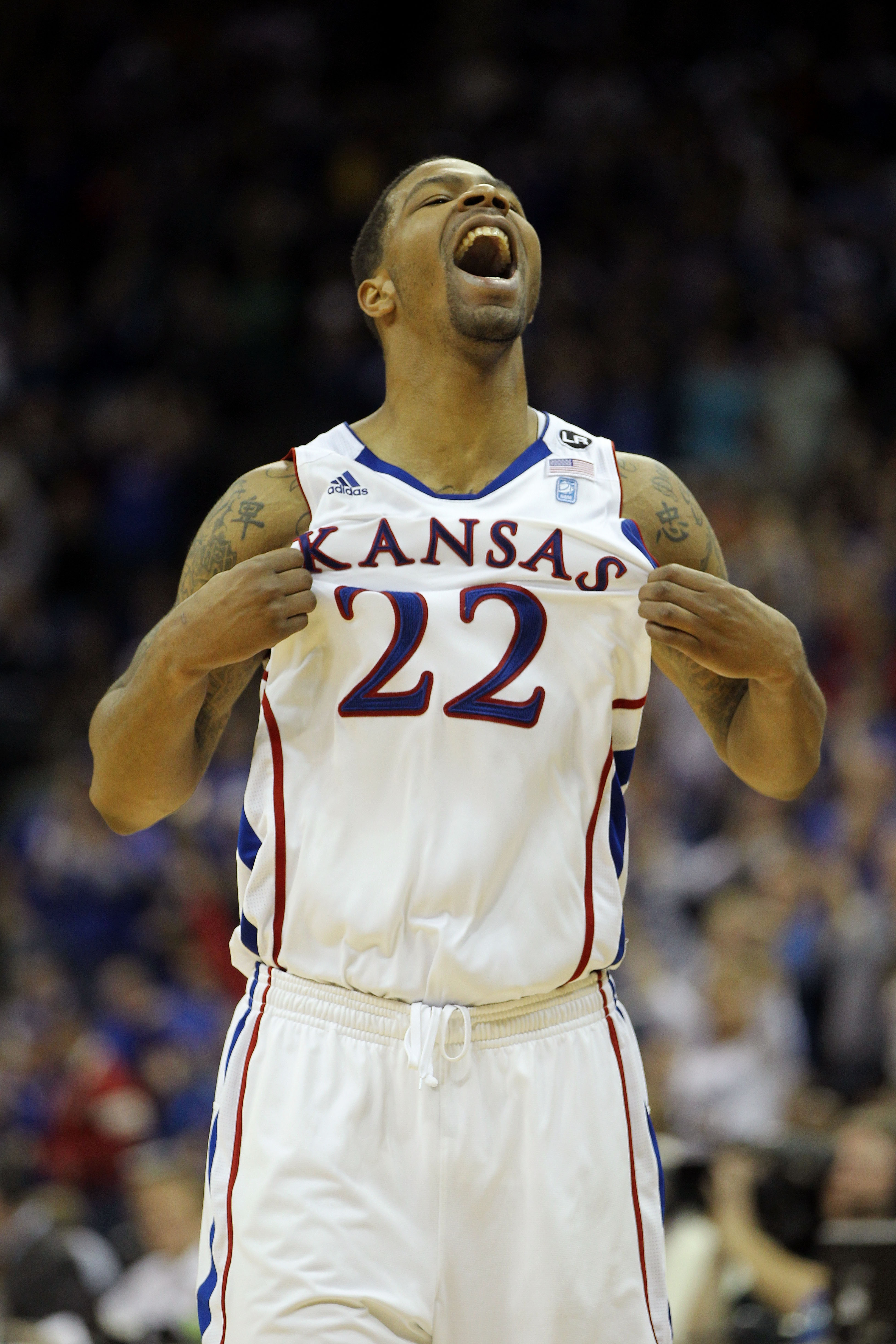 KANSAS CITY, MO - MARCH 12:  Marcus Morris #22 of the Kansas Jayhawks celebrates after a play against the Texas Longhorns during the 2011 Phillips 66 Big 12 Men's Basketball Tournament championship game at Sprint Center on March 12, 2011 in Kansas City, M