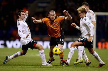 BOLTON, ENGLAND - FEBRUARY 01: David Jones of Wolves (C) in action with Mark Davies (L) and Stuart Holden (R) of Bolton during the Barclays Premier League match between Bolton Wanderers and Wolverhampton Wanderers at Reebok Stadium on February 2, 2011 in