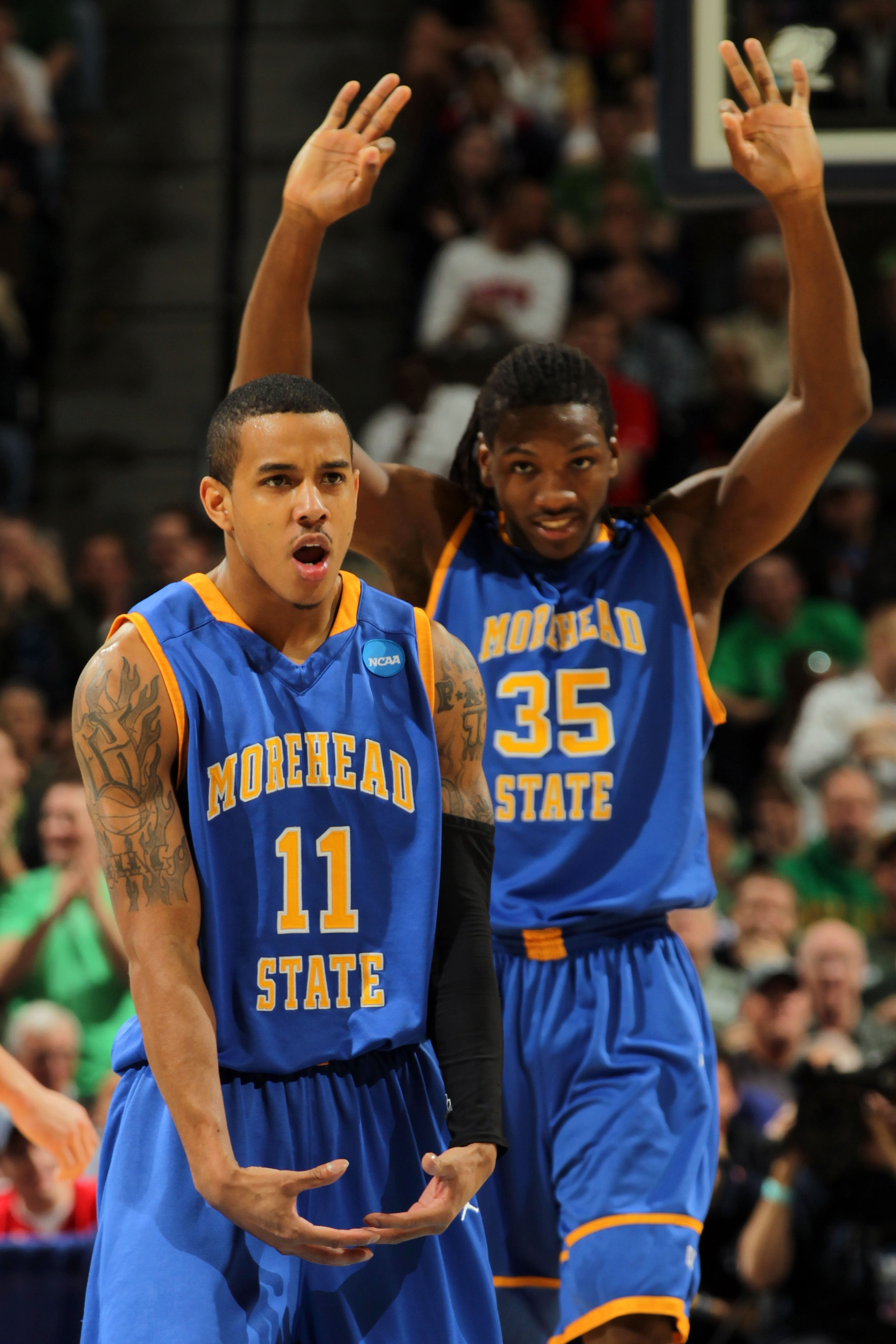 DENVER, CO - MARCH 17:  Terrance Hill #11 of the Morehead State Eagles reacts after hitting a three pointer in the second half as Kenneth Faried #35 looks on against the Louisville Cardinals during the second round of the 2011 NCAA men's basketball tourna