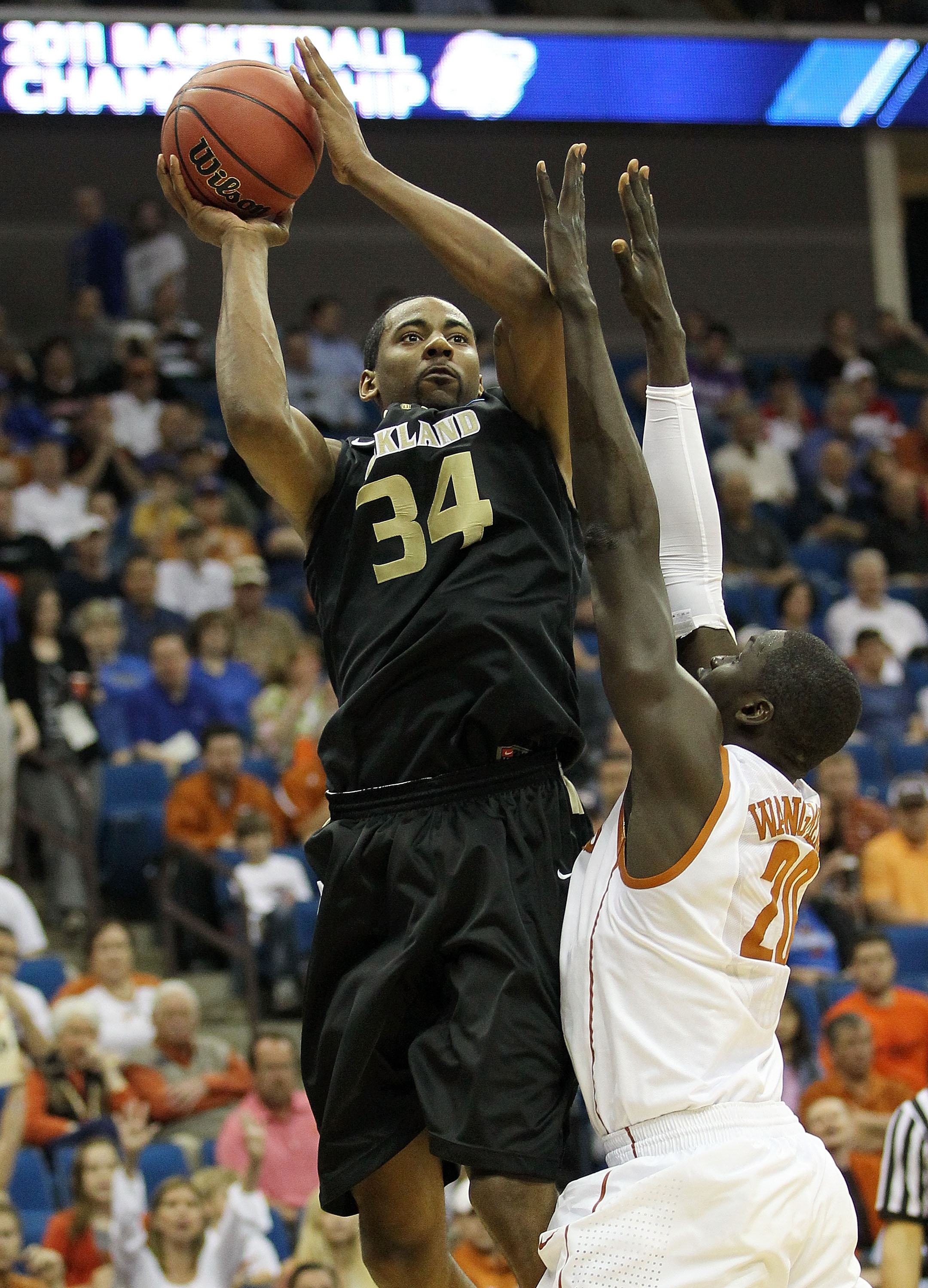 TULSA, OK - MARCH 18:  Keith Benson #34 of the Oakland Golden Grizzlies goes up for a shot against Alexis Wangmene #20 of the Texas Longhorns during the second round game of the 2011 NCAA men's basketball tournament at BOK Center on March 18, 2011 in Tuls