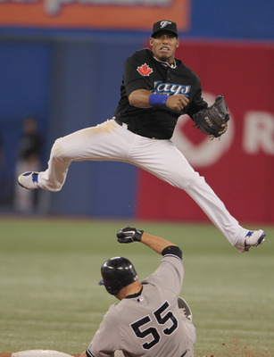 TORONTO, ON - APRIL 20:  Yunel Escobar #5 of the Toronto Blue Jays makes a play at second base on Russell Martin #55 of the New York Yankees during their game at Rogers Centre on April 20, 2011 in Toronto, Canada.  (Photo by Scott Halleran/Getty Images)
