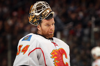 DENVER, CO - FEBRUARY 14:  Goalie Mikka Kiprusoff #34 of the Calgary Flames looks on during a break in the action against the Colorado Avalanche at the Pepsi Center on February 14, 2011 in Denver, Colorado. The Flames defeated the Avalanche 9-1.  (Photo b