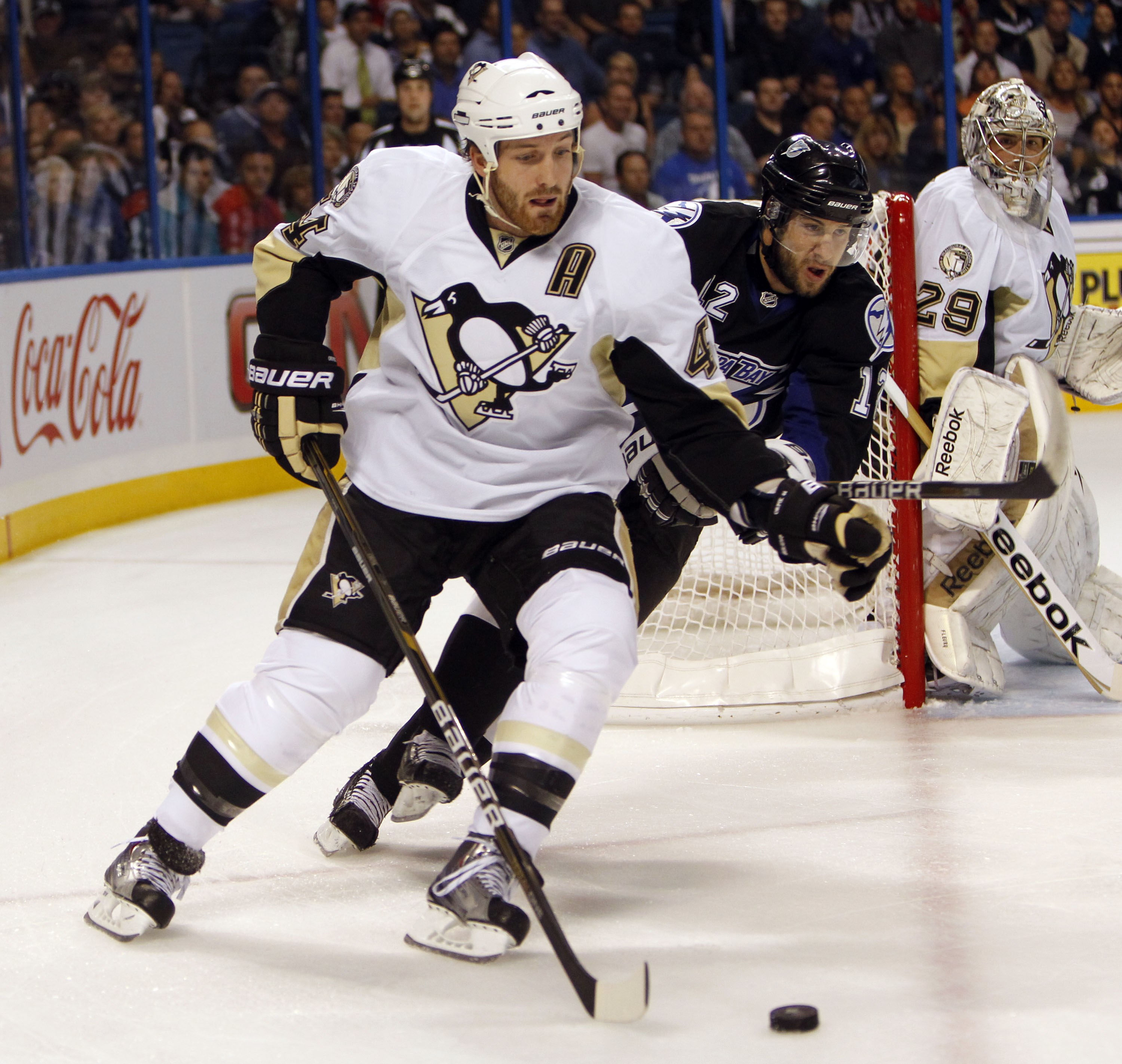 TAMPA, FL - APRIL 25: Brooks Orpik #44 of the Pittsburgh Penguins skates with the puck against Simon Gagne #12 of the Tampa Bay Lightning in Game Six of the Eastern Conference Quarterfinals during the 2011 NHL Stanley Cup Playoffs at the St. Pete Times Fo
