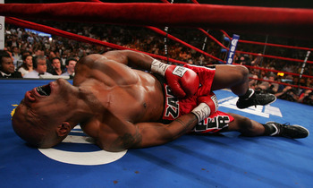 NEW YORK - JUNE 9: Zab Judah lays in agony on the canvas after being hit by a second low blow by Miguel Cotto of Puerto Rico during their WBA Welterweight Championship bout on June 9, 2007 at Madison Square Garden in New York City. (Photo by Nick Laham/Ge