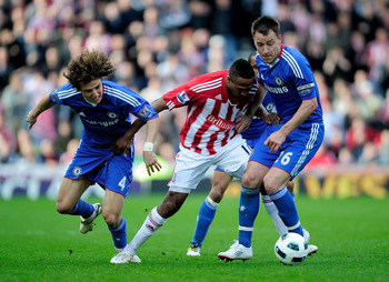 STOKE ON TRENT, ENGLAND - APRIL 02:  Ricardo Fuller of Stoke City battles for the ball with David Luiz (L) and John Terry of Chelsea during the Barclays Premier League match between Stoke City and Chelsea at the Britannia Stadium on April 2, 2011 in Stoke