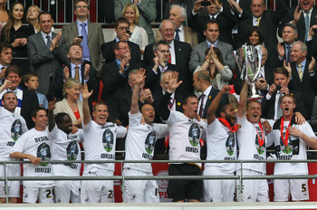 LONDON, ENGLAND - MAY 30: Garry Monk, Captain of Swansea leads celebrations with the trophy after winning the npower Championship Playoff Final between Reading and Swansea City at Wembley Stadium on May 30, 2011 in London, England. (Photo by Dean Mouhta