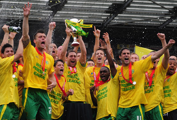 NORWICH, ENGLAND - MAY 07: Norwich City players celebrate promotion during the npower Championship match between Norwich City and Coventry City at Carrow Road on May 7, 2011 in Norwich, England. (Photo by Jamie McDonald/Getty Images)