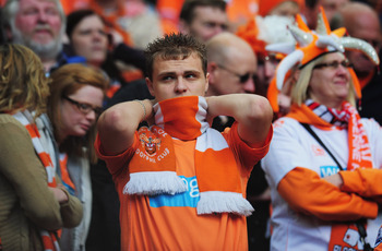 MANCHESTER, ENGLAND - MAY 22: A Blackpool fan looks dejected as they are relegated during the Barclays Premier League match between Manchester United and Blackpool at Old Trafford on May 22, 2011 in Manchester, England. (Photo by Shaun Botterill/Getty I