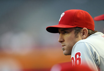 Chase Utley of the Philadelphia Phillies watches from the dugout