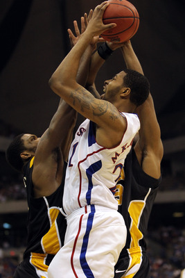 SAN ANTONIO, TX - MARCH 27:  Markieff Morris #21 of the Kansas Jayhawks shoots against Jamie Skeen #21 of the Virginia Commonwealth Rams during the southwest regional final of the 2011 NCAA men's basketball tournament at the Alamodome on March 27, 2011 in