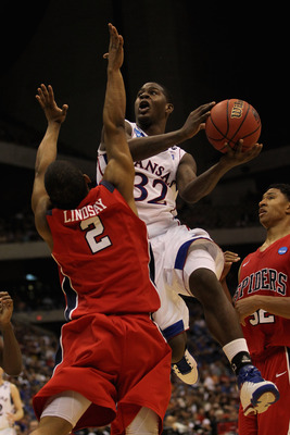 SAN ANTONIO, TX - MARCH 25:  Josh Selby #32 of the Kansas Jayhawks goes to the basket against Cedrick Lindsay #2 of the Richmond Spiders during the southwest regional of the 2011 NCAA men's basketball tournament at the Alamodome on March 25, 2011 in San A