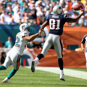 MIAMI - NOVEMBER 23: Wide receiver Randy Moss #81 of the New England Patriots pulls in a one-handed catch over cornerback Jason Allen #32 of the Miami Dolphins at Dolphin Stadium on November 23, 2008 in Miami, Florida.  (Photo by Doug Benc/Getty Images)