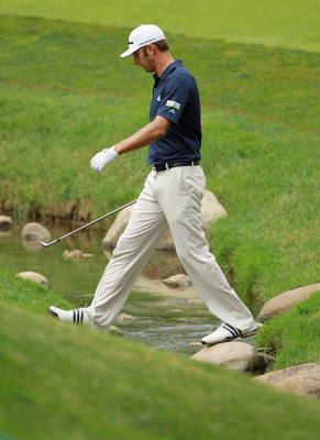 DUBLIN, OH - JUNE 03:  Dustin Johnson crosses a stream on the 17th hole during the second round of the Memorial Tournament presented by Nationwide Insurance at the Muirfield Village Golf Club on June 3, 2011 in Dublin, Ohio.  (Photo by Scott Halleran/Gett