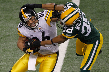 ARLINGTON, TX - FEBRUARY 06:  Hines Ward #86 of the Pittsburgh Steelers tries to avoid the tackle of Tramon Williams #38 of the Green Bay Packers during Super Bowl XLV at Cowboys Stadium on February 6, 2011 in Arlington, Texas.  (Photo by Joe Robbins/Gett
